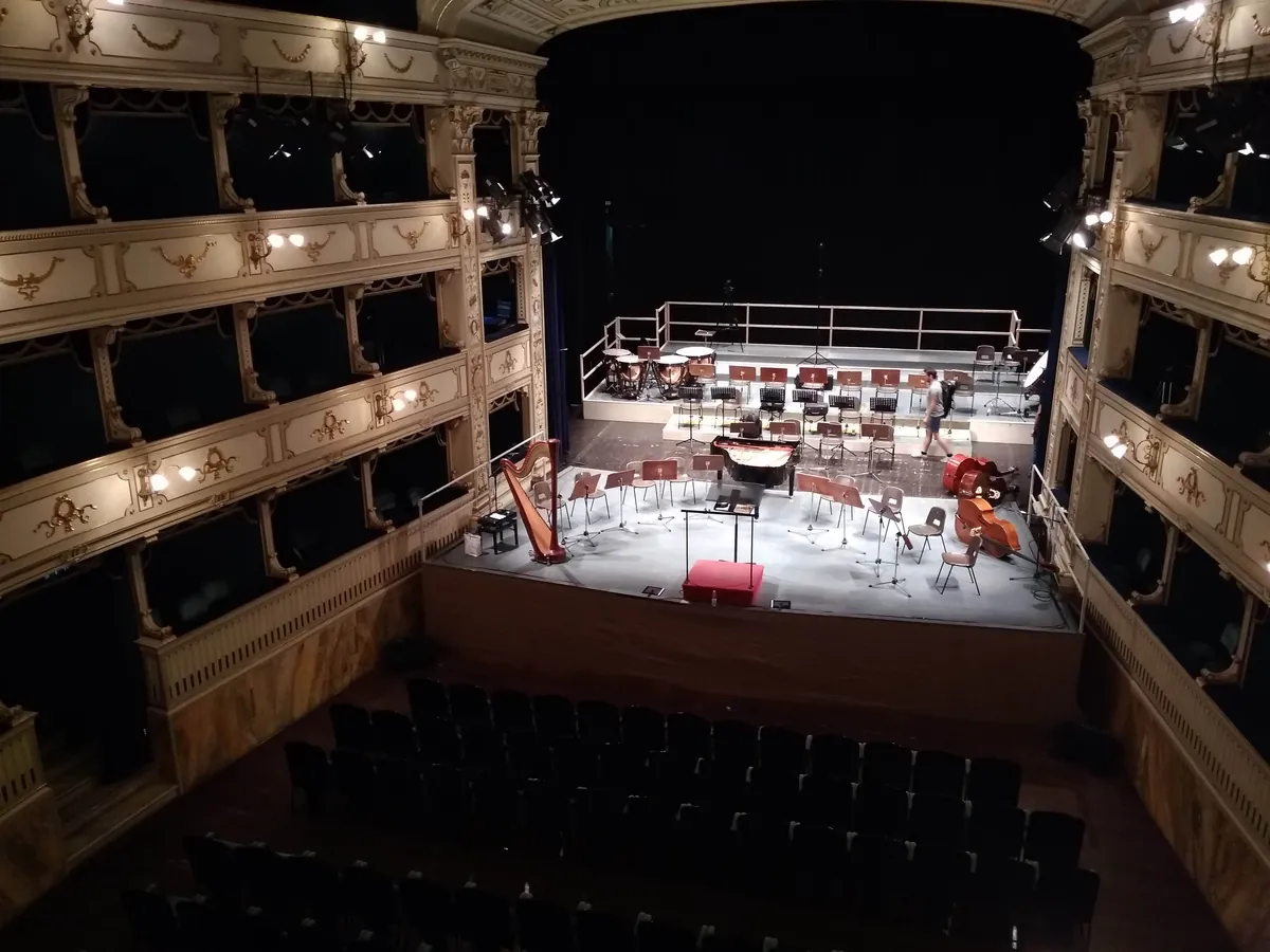 The stage of a historic Italian theatre seen from the gallery, set for a concert